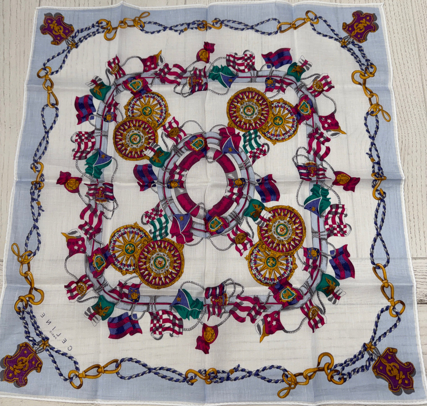 Colorful patterned fabric with decorative elements on a wooden surface
