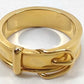 A yellow gold ring with a textured, multi-band design and a small decorative element on the front, photographed on a plain white background.