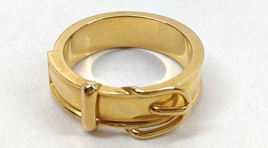 A yellow gold ring with a textured, multi-band design and a small decorative element on the front, photographed on a plain white background.