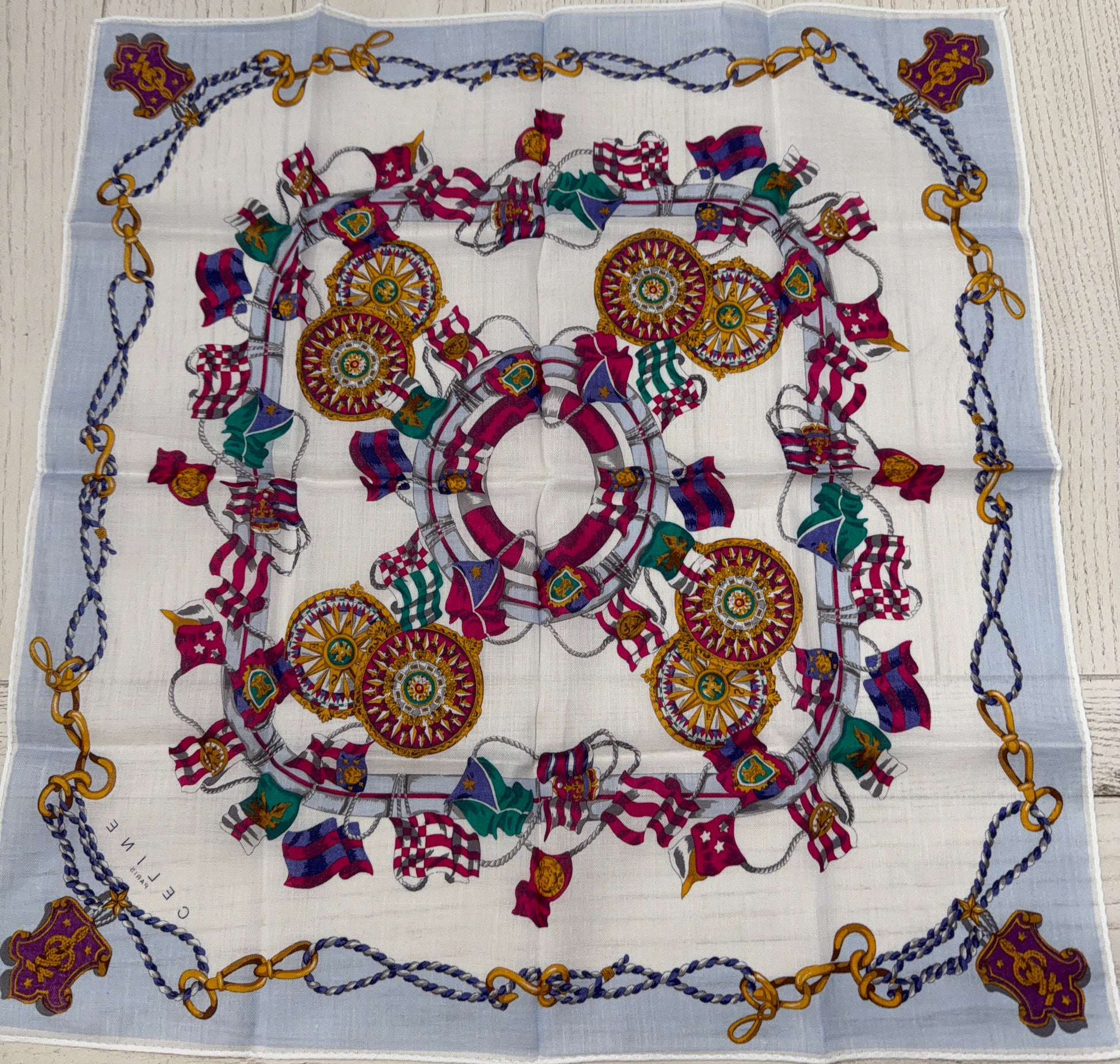 Colorful patterned fabric with decorative elements on a wooden surface