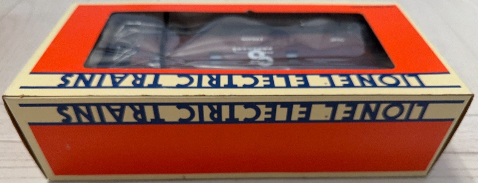 Box of Lionel Electric Trains on a light wooden surface